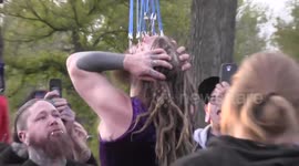Man suspended in the air by hooks in his face