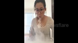 Woman blows smoke rings with e-cigarette to the beat of a dance song