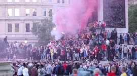 Sunderland Athletic Football Club fans let off flares as they gather in Trafalgar Square in London