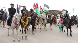 Palestinians take part in a rally marking the 74th anniversary of the