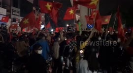Football fans celebrate creating a fanciful and vibrant atmosphere on the street after Vietnam won SEA Games 31