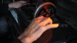 An elderly Palestinian Zakaria Al-Jayar, 82, repairs sewing machines at his shop