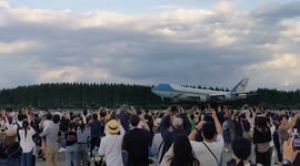 Festival-goers in Japan welcome Air Force One carrying Joe Biden