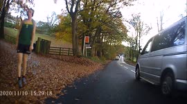 Jaguar car close passes a cyclist almost hitting Reliant Robin