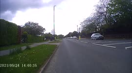Volvo HGV close passes a cyclist in Bramhope West Yorkshire at a pedestrian refuge