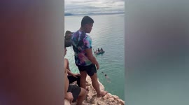 Nervous tourist slips off cliff-edge while diving into sea