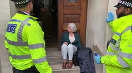 Activist glues herself to London building hosting Shell meeting