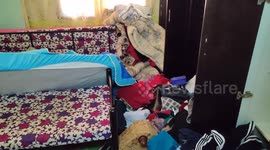 Family of Mohammad Al-Tubasi inspect their home after a raid by Israeli troops