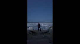 Large ice floe crashes against shore near Russian city of Yakutsk