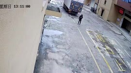 Unsuspecting man rolls away from truck's wheels after being knocked over