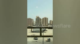 Workers watch sandstorm blow through buildings in Kuwait