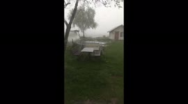 A powerful wind during a hurricane carried away a trampoline and a bench