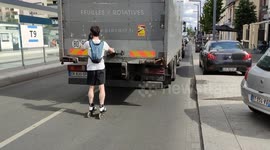 Paris roller blader clings to a truck to be towed down the street without the driver noticing
