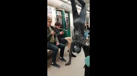 Spiderman puts on a show in the carriage of a St Petersburg metro train in Russia