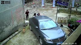 Woman prevents car from rolling down slope by 'catching' it in China