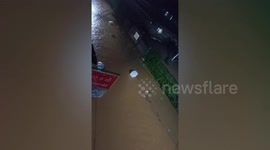 Locals trudge through knee-deep flood after heavy rain in Myanmar
