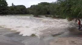 Motorcycle rider rescued after flash floods sweep him away while crossing bridge