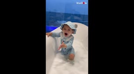 Adorable baby boy is having a great time in the bathtub