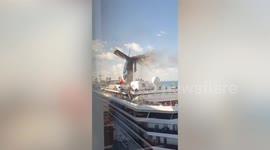 Firefighters douse Carnival cruise ship that burst into flame while docked in Grand Turk
