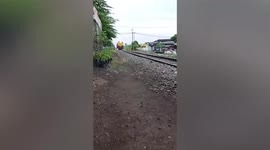 Train crashes into minibus driving over level cross in Indonesia