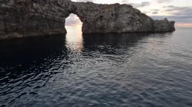 drone flaying above the sea crashes into a rock sinks and gets rescued