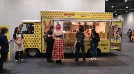 Hours-long queue for free food at Bob's Burgers Movie van at MCM Comic Con in London, UK