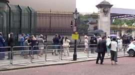 Royal Garden Party guests queue outside Buckingham Palace in drizzling rain - London