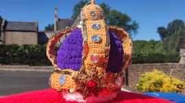 Royal Mail post box decorated with knitted crown for Queen's Platinum Jubilee