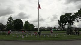 Boy and girl scouts place flags at the graves of late Veterans' at a flag placement event in the small town of Fair Lawn, NJ on May 28, 2022