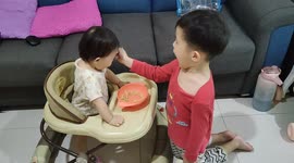 Heartwarming moment of a 4-year-old boy feeding her baby sister food