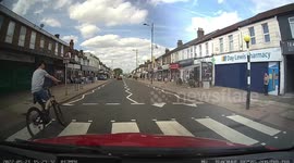 Boy on a bike nearly gets himself seriously hurt swerving in front of a car in London