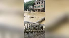 Farmland rapidly engulfed by floodwater as storm hits southern China