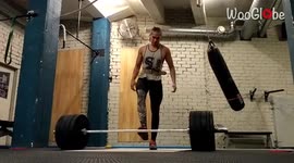 'Weightlifter loses balance and collapses while holding a barbell 
'