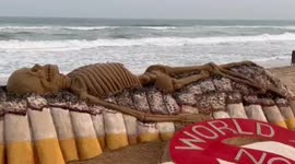 Artist sculpts skeleton out of sand to mark World No Tobacco Day