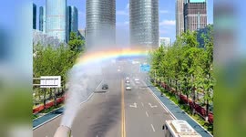 Rainbow road! Spectrum of colours appears as truck sprays mist in China
