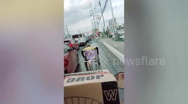 Loyal pet dog helps push owner's wheelchair across steep road bridge