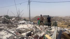 Palestinians inspect the rubble of thier house after demolished by Israeli bulldozers