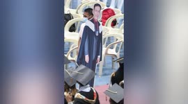 Grieving father marches with life-size cutout of dead son to youngster's graduation ceremony