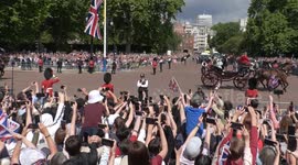 Royal fans climb on railings for a glimpse of royalty as thousands watch Jubilee Trooping the Colour parade in London
