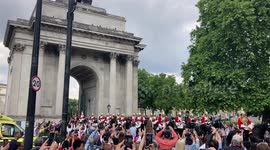 Horseguards parade through Wellington Arch to Buckingham Palace amid huge crowd