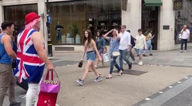 A shopper wearing a Union Jack dress similar to one worn by Geri Halliwell from the Spice Girls attracts attention on Regent Street, London, this afternoon. Many streets in London’s west end are currently decorated with Union Jack flags to mark Queen Eliz