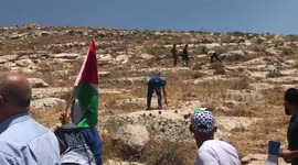 Palestinian protesters clash with Israeli forces during a demonstration against settlements in the village of Beit Dajan