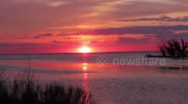 Pelicans and Geese swiming towards the beautiful sunrise on Lake Superior in Ashland