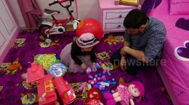 A Palestinian girl, Maria Abu Hatab, 6, plays with her toys on the International Day of Innocent Children Victims of Aggression