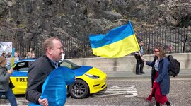 Ukrainian protesters march past Edinburgh Castle in protest of the Russian invasion