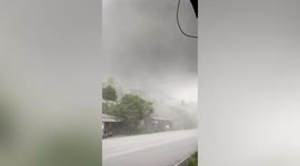 Choking ash covers roads and houses after Philippines volcano eruption