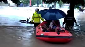 Excavators used to transport students through floodwater to exam centre in China