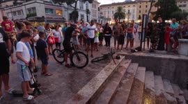 Biker balance on front wheel down the stairs then jumps into the lake