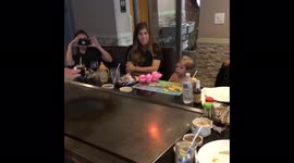Baby surprised by hibachi flame
