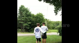 Two boys on a rope swing